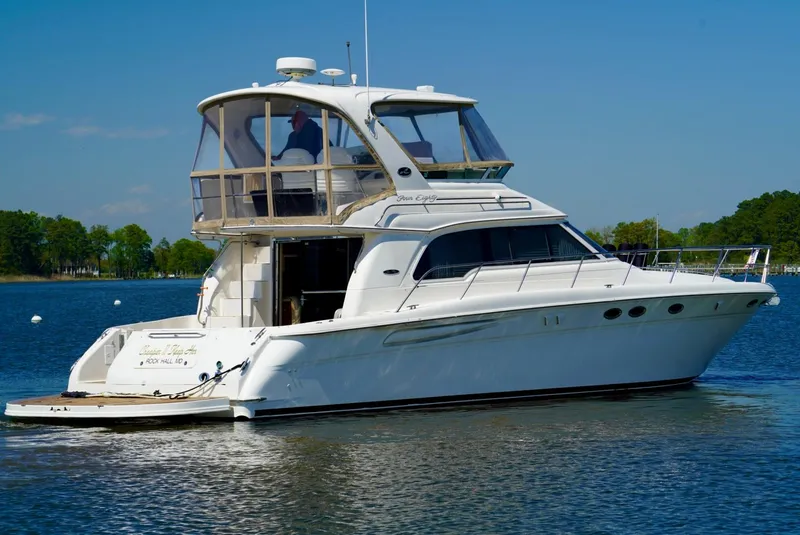 Slide: The Image of 2002 Sea Ray 480 Sedan Bridge yacht on calm water. - 13