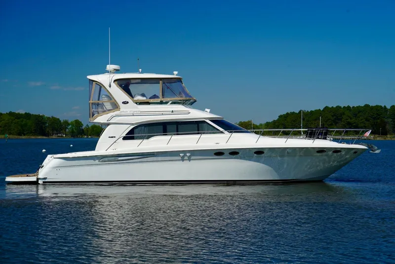 Slide: The Image of 2002 Sea Ray 480 Sedan Bridge yacht on calm water. - 14
