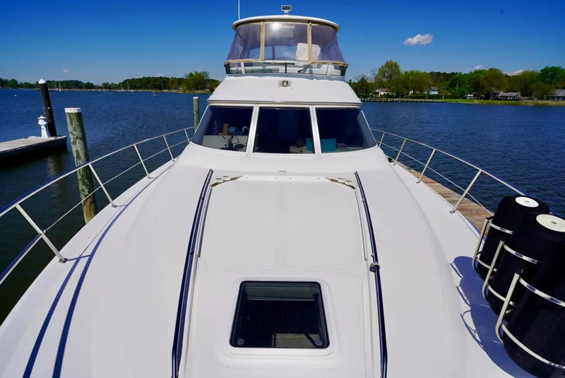 Slide: The Image of 2002 Sea Ray 480 Sedan Bridge yacht docked on a sunny day. - 15