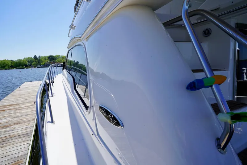 Slide: The Image of 2002 Sea Ray 480 Sedan Bridge yacht docked at a marina. - 17