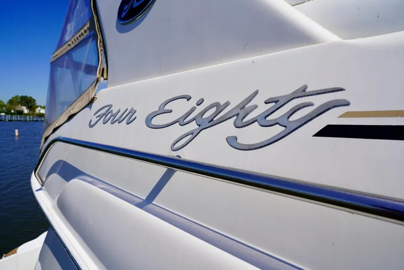 Slide: The Image of 2002 Sea Ray 480 Sedan Bridge boat with Four Eighty logo. - 18
