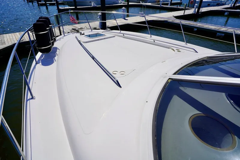 Slide: The Image of 2002 Sea Ray 480 Sedan Bridge yacht bow view at marina. - 19