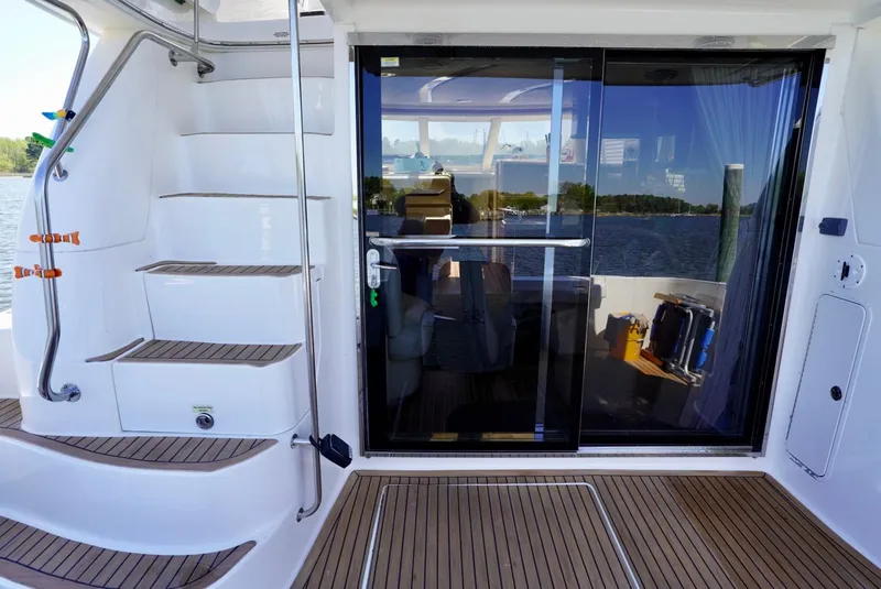 Slide: The Image of 2002 Sea Ray 480 Sedan Bridge yacht with teak deck and sliding glass door. - 21