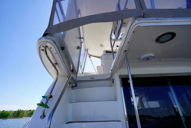 Slide: The Image of 2002 Sea Ray 480 Sedan Bridge, view of the stairs and upper deck. - 28