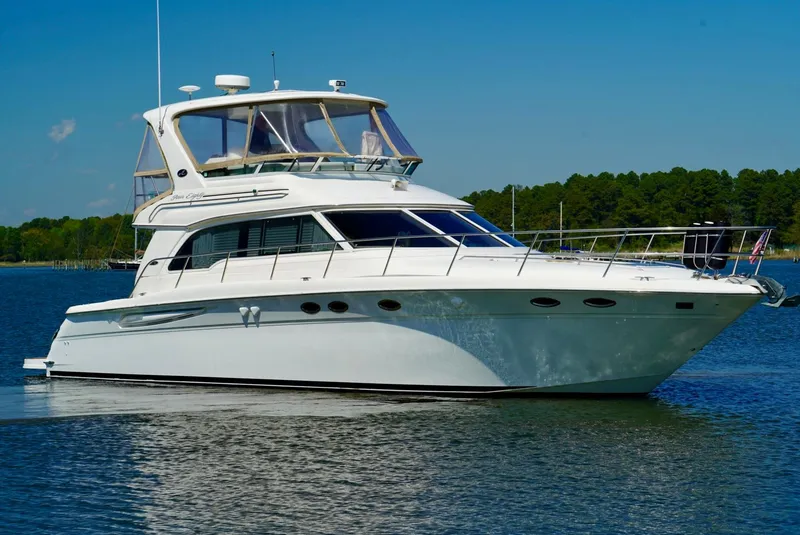 Slide: The Image of 2002 Sea Ray 480 Sedan Bridge yacht on calm water. - 3