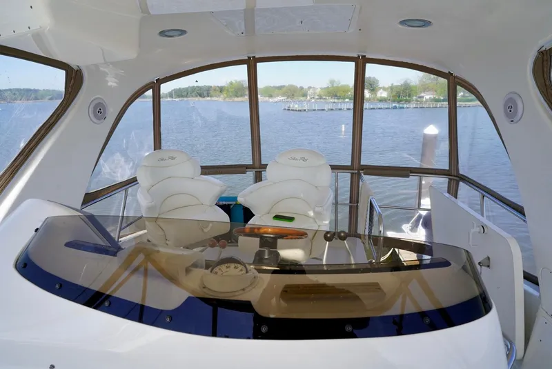 Slide: The Image of Interior view of 2002 Sea Ray 480 Sedan Bridge yacht helm station. - 30