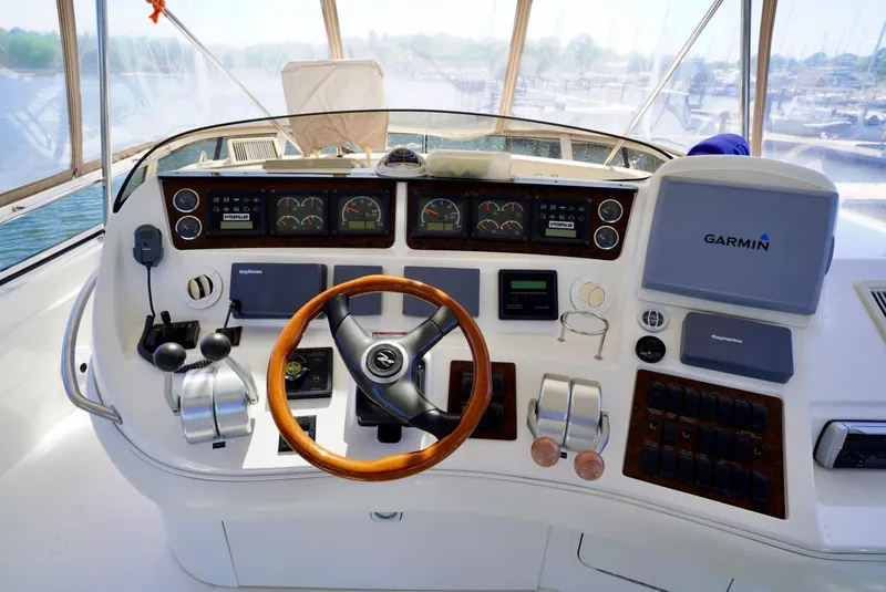 Slide: The Image of 2002 Sea Ray 480 Sedan Bridge helm with Garmin navigation system. - 32