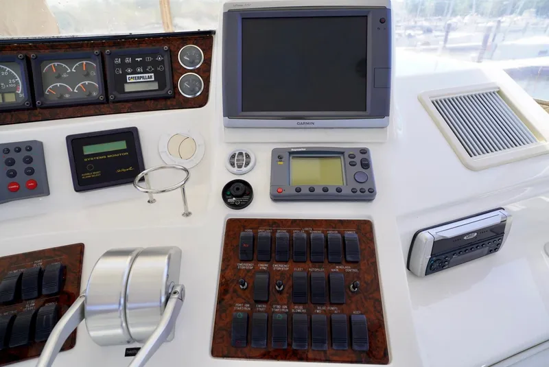 Slide: The Image of Control panel of a 2002 Sea Ray 480 Sedan Bridge yacht with navigation and monitoring systems. - 35