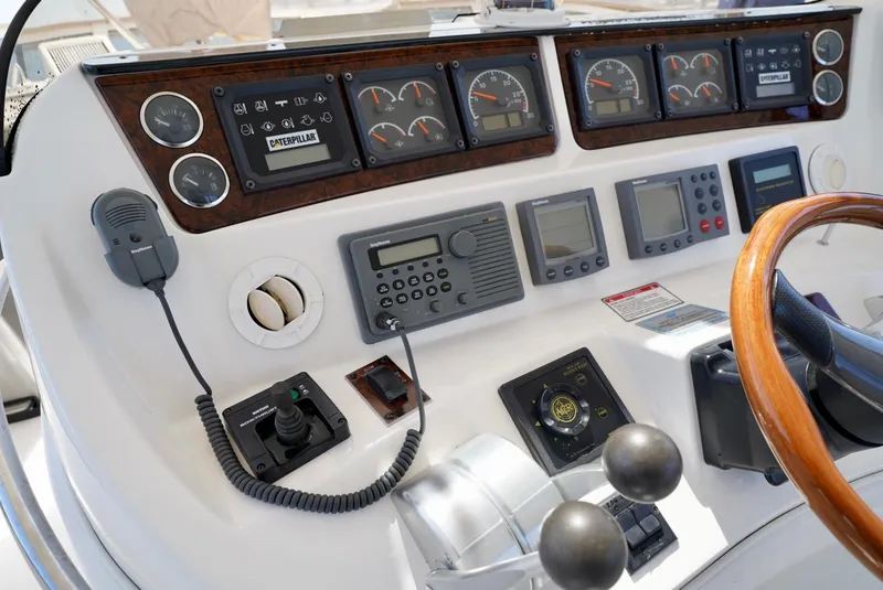 Slide: The Image of Control panel of a 2002 Sea Ray 480 Sedan Bridge yacht with various gauges and instruments. - 37