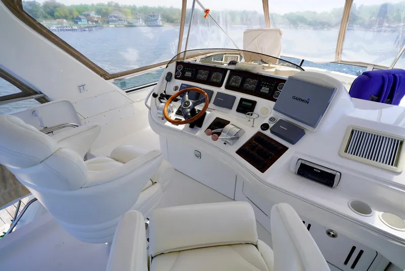 Slide: The Image of 2002 Sea Ray 480 Sedan Bridge yacht helm with modern navigation equipment. - 38
