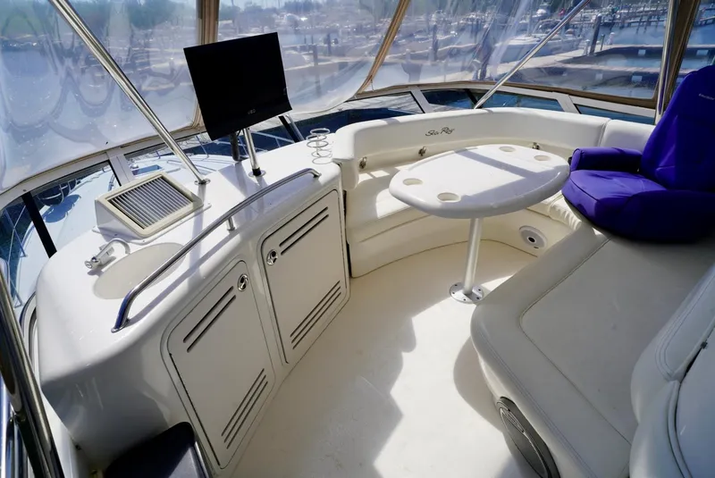 Slide: The Image of 2002 Sea Ray 480 Sedan Bridge interior with seating, table, and helm station. - 41