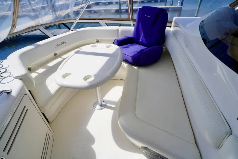 Slide: The Image of 2002 Sea Ray 480 Sedan Bridge boat interior with white seating and table. - 43
