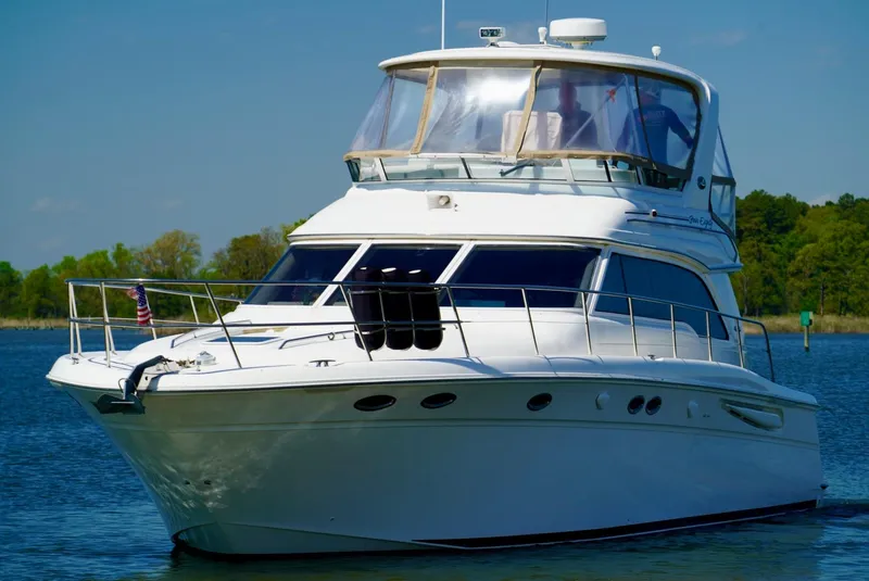 Slide: The Image of 2002 Sea Ray 480 Sedan Bridge yacht on calm water. - 5