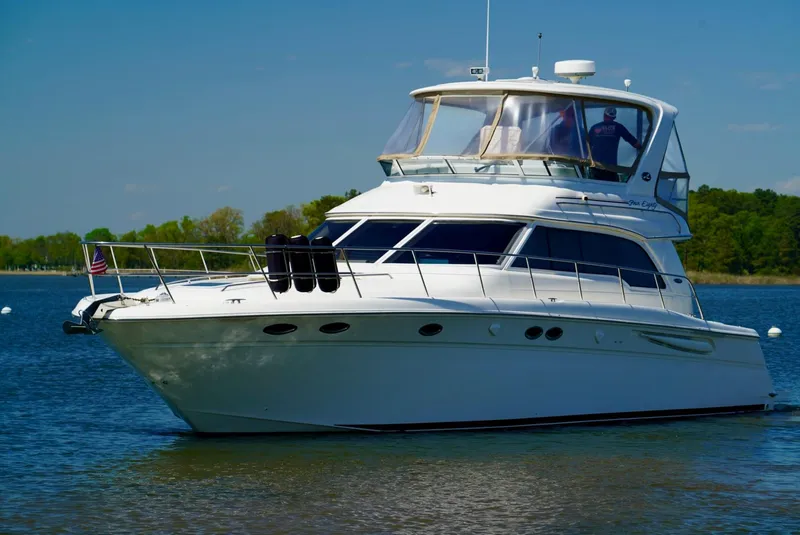 Slide: The Image of 2002 Sea Ray 480 Sedan Bridge yacht on calm water. - 6