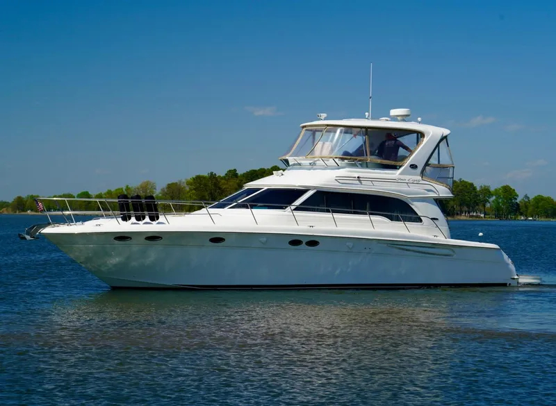 Slide: The Image of 2002 Sea Ray 480 Sedan Bridge yacht on calm water. - 7