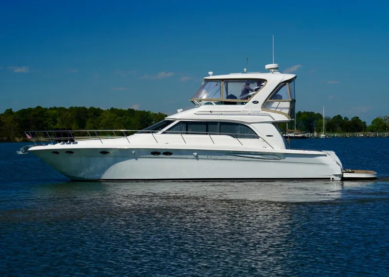 Slide: The Image of 2002 Sea Ray 480 Sedan Bridge yacht on calm water. - 8