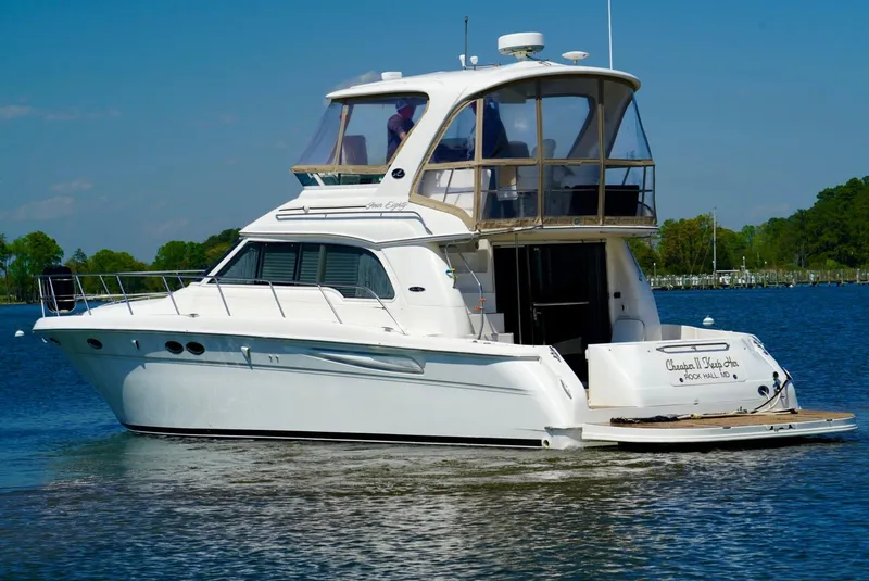 Slide: The Image of 2002 Sea Ray 480 Sedan Bridge yacht cruising on a calm lake. - 9