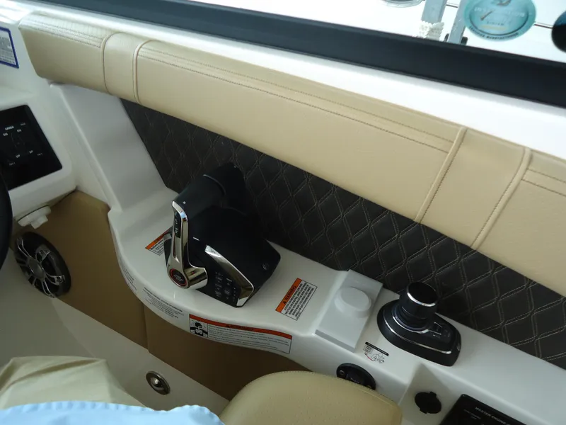 Slide: The Image of Interior controls of a 2022 Sea Ray 350 SLX boat with beige upholstery. - 13