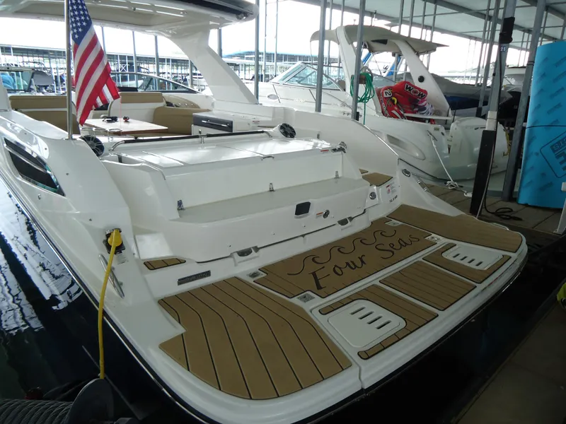 Slide: The Image of 2022 Sea Ray 350 SLX luxury boat docked with American flag. - 2