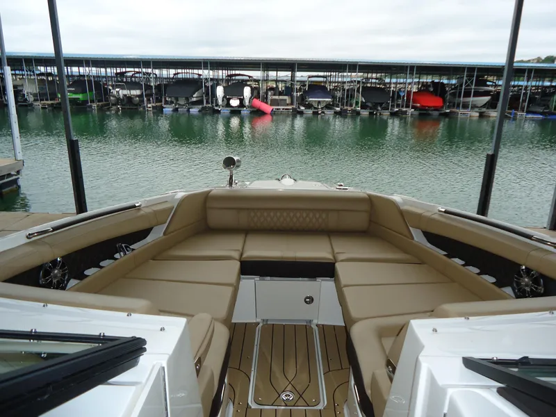 Slide: The Image of 2022 Sea Ray 350 SLX boat with spacious seating at a marina. - 8