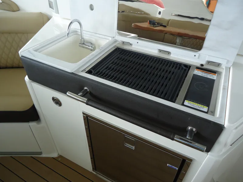 Slide: The Image of Outdoor kitchen on 2022 Sea Ray 350 SLX boat with sink and grill. - 9