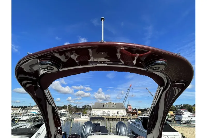 Slide: The Image of 2021 Bennington QX 25 Swingback boat at a marina under a clear blue sky. - 14