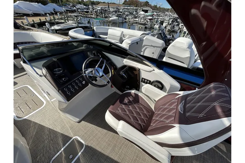 Slide: The Image of 2021 Bennington QX 25 Swingback boat interior with luxurious seating and modern dashboard. - 15