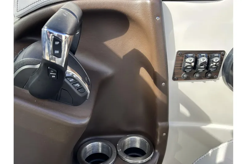 Slide: The Image of Close-up of 2021 Bennington QX 25 Swingback boat controls and cup holders. - 24