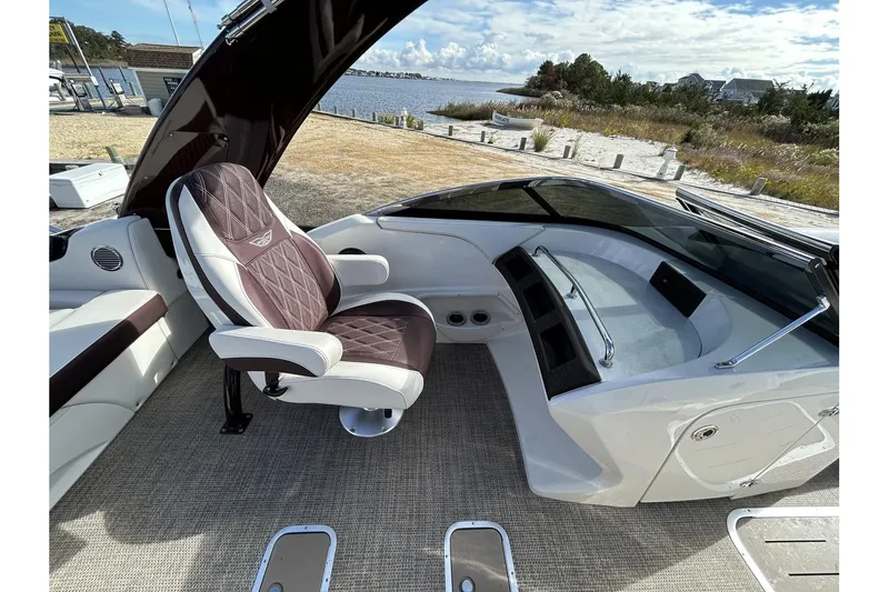 Slide: The Image of 2021 Bennington QX 25 Swingback boat interior with captain's chair and dashboard. - 26