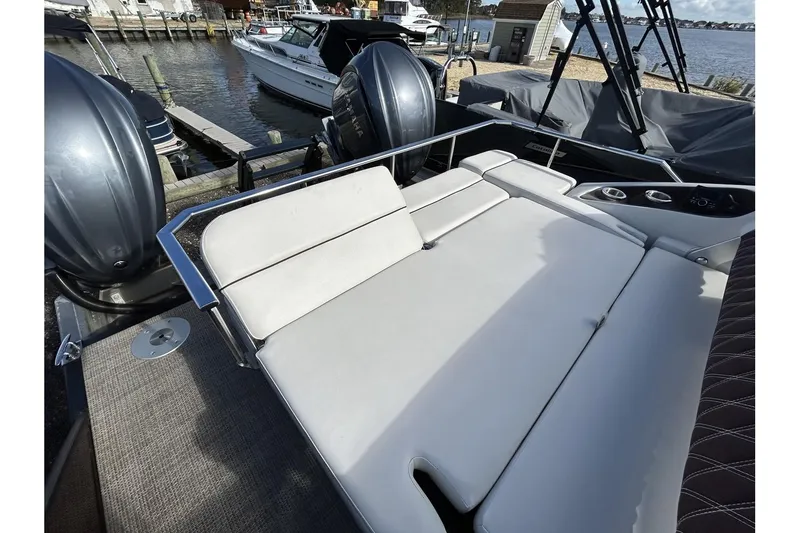 Slide: The Image of 2021 Bennington QX 25 Swingback boat with spacious sun lounge and dual outboard motors. - 31