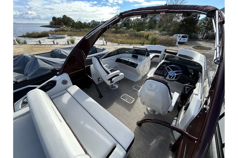 Slide: The Image of 2021 Bennington QX 25 Swingback pontoon boat interior with luxurious seating and modern helm. - 37