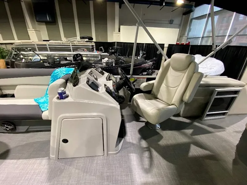 Slide: The Image of 2024 SunChaser Geneva 24 SB DH boat interior with captain's chair and control console. - 12