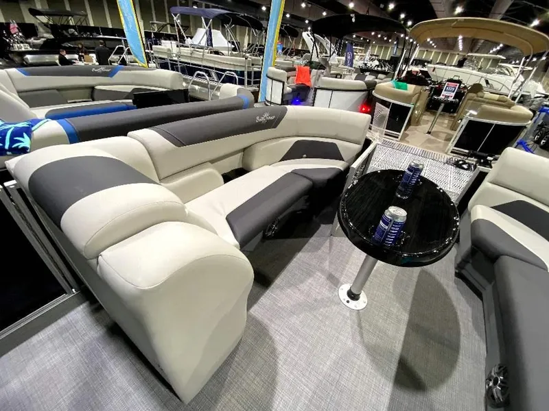 Slide: The Image of 2024 SunChaser Geneva 24 SB DH pontoon boat interior with plush seating and table. - 14