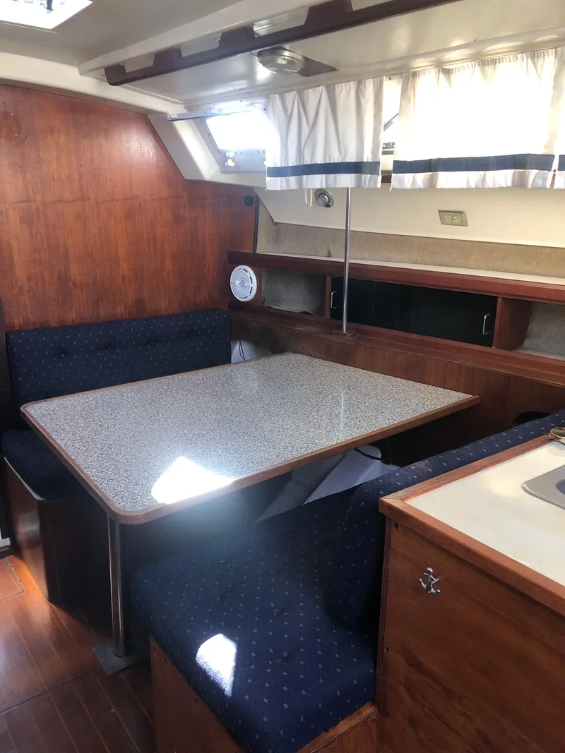 Slide: The Image of Interior of 1983 Hunter 34 sailboat with wooden finish and dining area. - 14