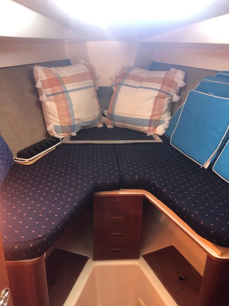 Slide: The Image of 1983 Hunter 34 sailboat cabin with cozy bedding and cushions. - 19