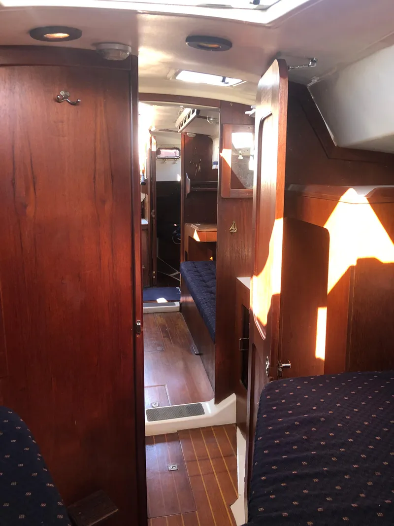 Slide: The Image of Interior of 1983 Hunter 34 sailboat with wooden cabinetry and cozy seating. - 21