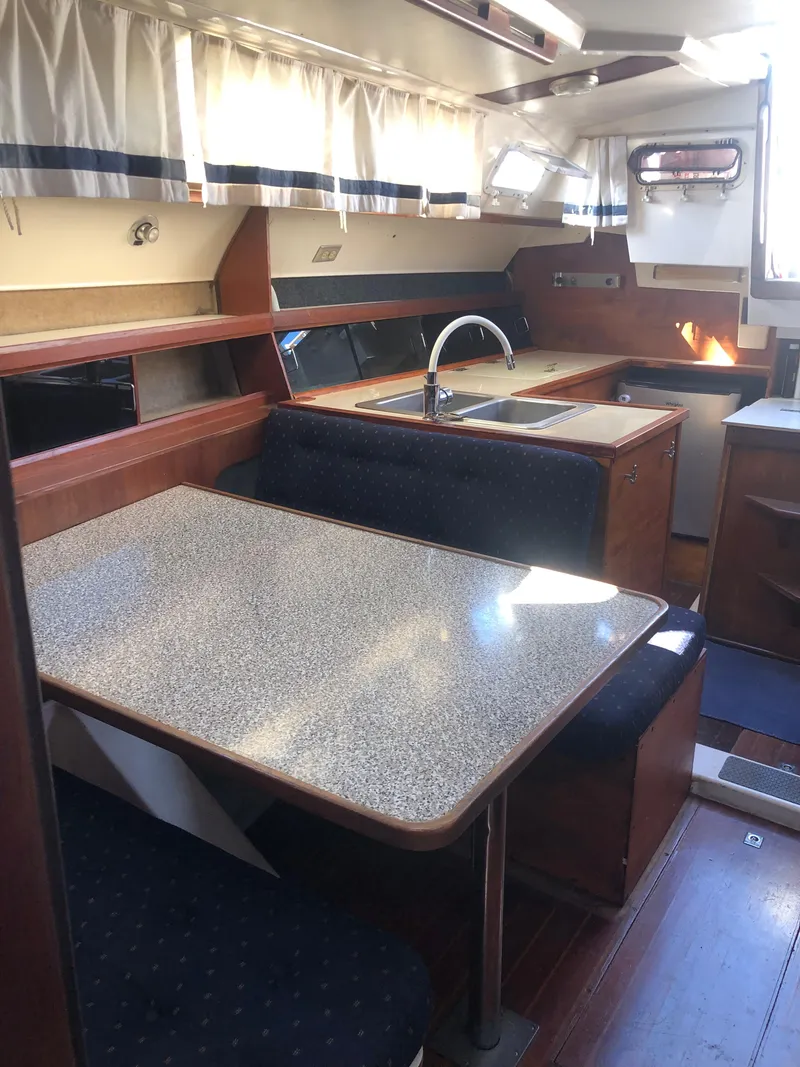 Slide: The Image of 1983 Hunter 34 sailboat interior with dining area and kitchenette. - 23