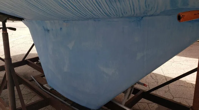 Slide: The Image of 1983 Hunter 34 sailboat hull on a stand, blue finish. - 5