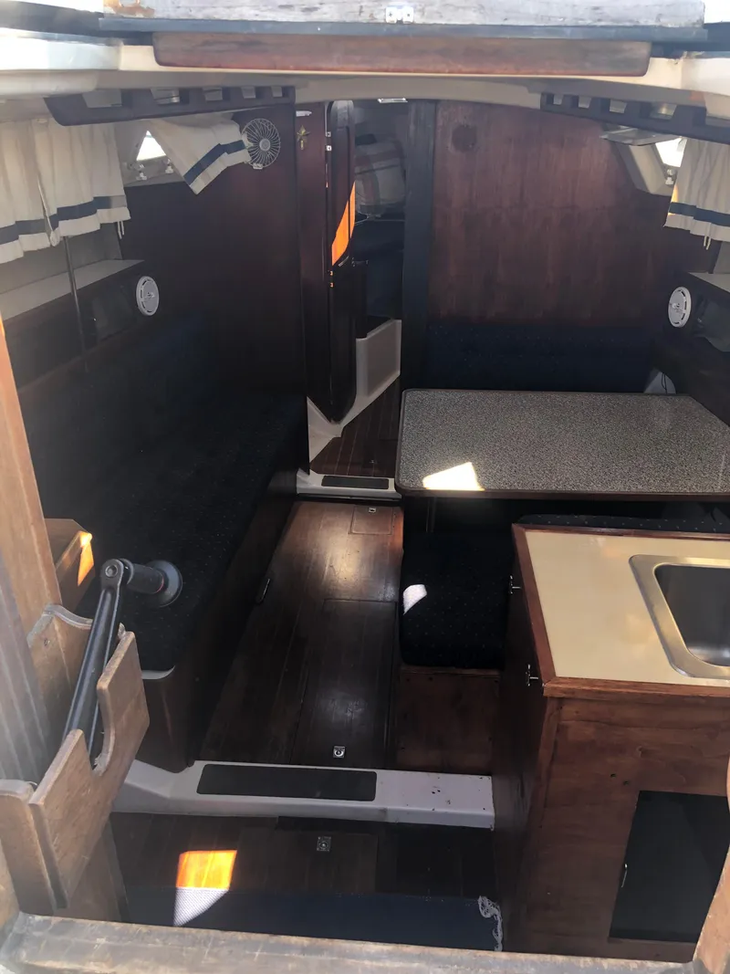 Slide: The Image of Interior of 1983 Hunter 34 sailboat with wood finish and compact layout. - 6