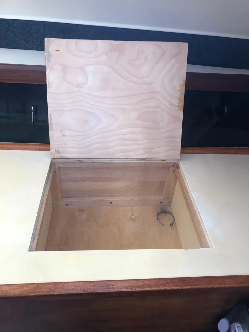 Slide: The Image of Open wooden storage compartment on 1983 Hunter 34 sailboat interior. - 9