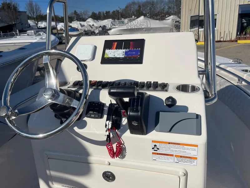 Slide: The Image of 2024 Sea Chaser 20 HFC boat console with steering wheel and navigation display. - 3