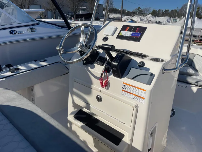 Slide: The Image of 2024 Sea Chaser 20 HFC boat console with steering wheel and control panel. - 4