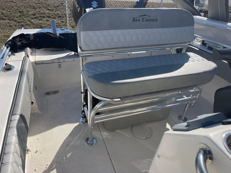 Slide: The Image of 2024 Sea Chaser 20 HFC boat interior with cushioned seating and stainless steel frame. - 5