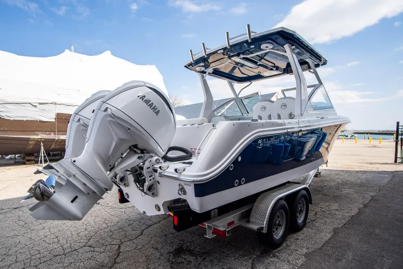 Slide: The Image of 2024 Edgewater 262 CX boat on a trailer, featuring a Yamaha outboard motor. - 3