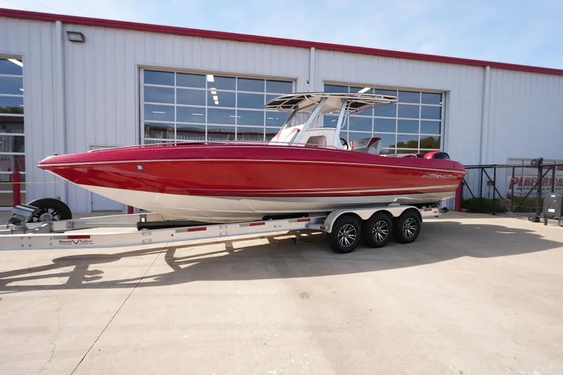 Slide: The Image of 2016 Sunsation 29 CCX boat on a trailer outside a warehouse. - 1