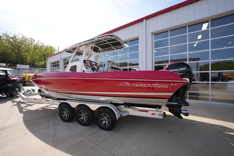 Slide: The Image of 2016 Sunsation 29 CCX boat on a trailer outside a garage. - 2