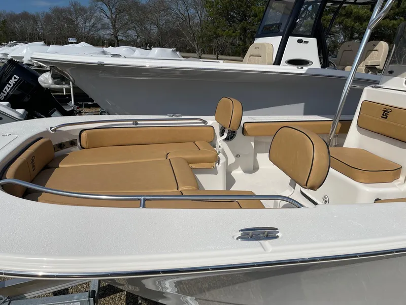 Slide: The Image of 2024 Carolina Skiff 24 Ultra Elite boat with tan seating and stainless steel railings. - 3