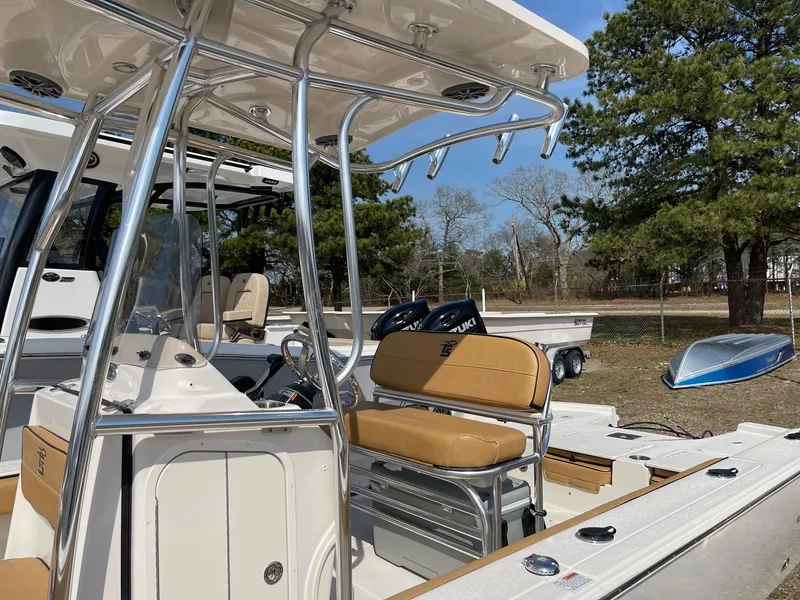 Slide: The Image of 2024 Carolina Skiff 24 Ultra Elite boat with tan seating and stainless steel frame. - 4