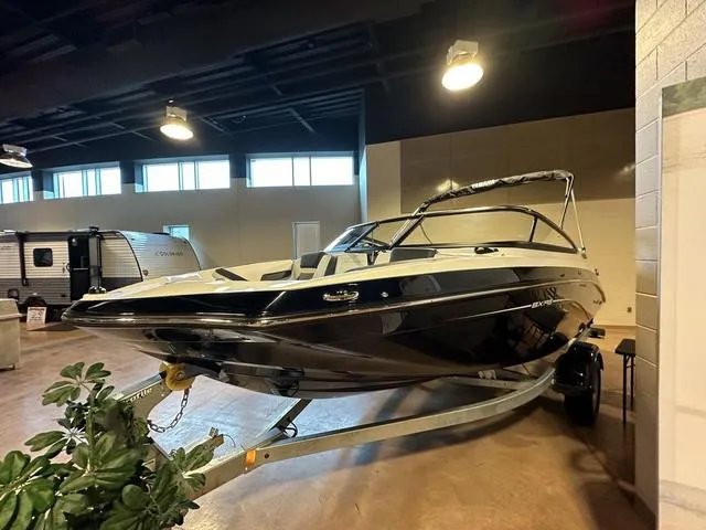 Slide: The Image of 2024 Yamaha Boats SX195 on display in an indoor showroom. - 4