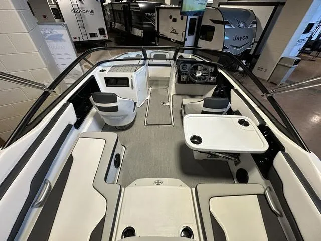 Slide: The Image of 2024 Yamaha Boats SX195 interior with seating and table, displayed in showroom. - 8